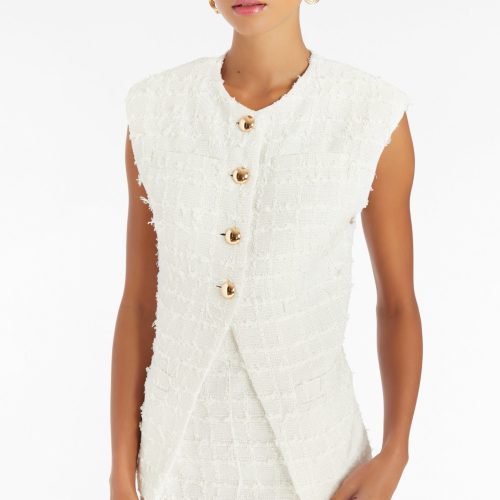 Girl in white tweed vest, front facing.