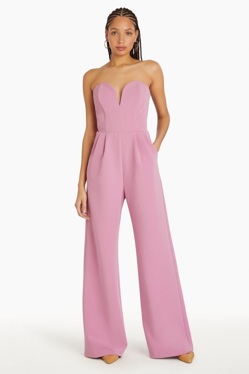 Girl in pink jumpsuit, front facing.