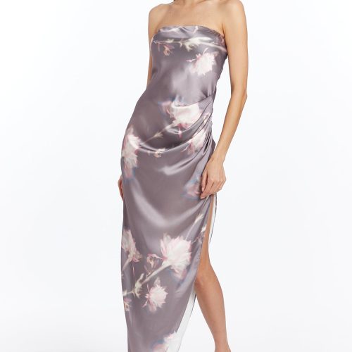 Girl in long silk floral dress, side facing.