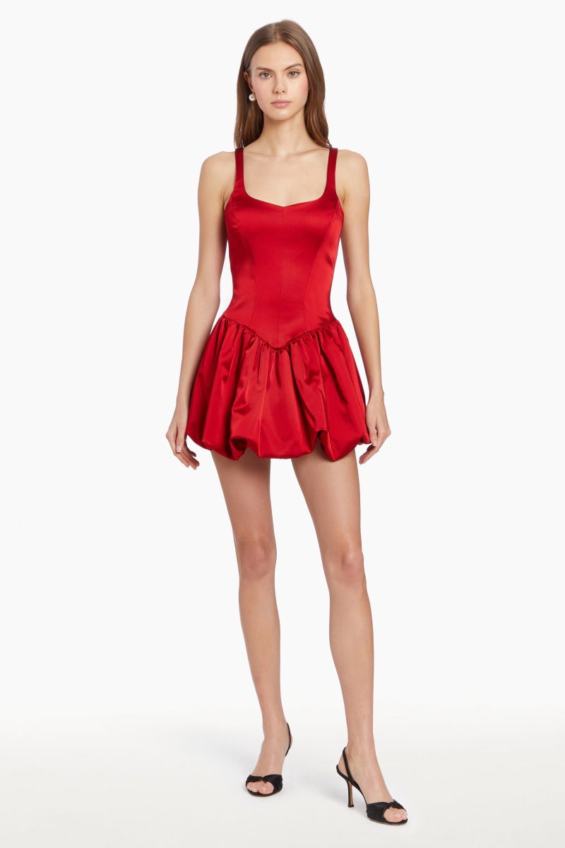 Girl in red dress with bubble hem, front facing.