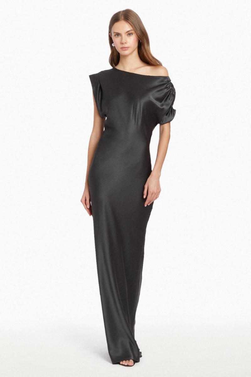 Girl in silk one shoulder black maxi dress, front facing.